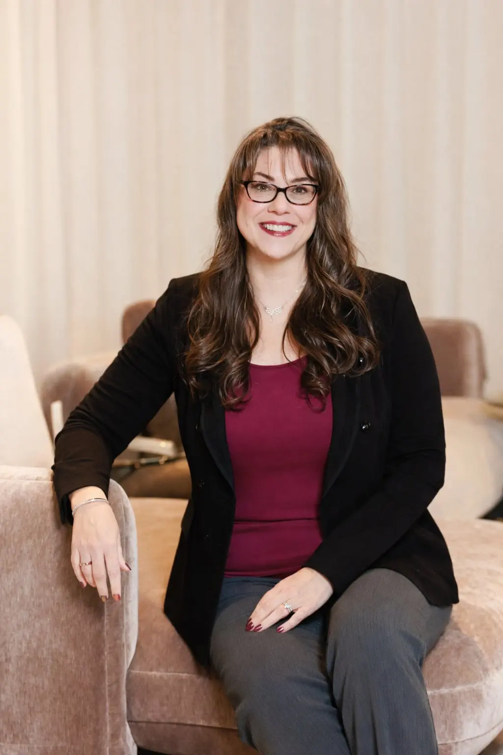 Michele Kiefert interior designer portrait seated in a modern living space, showcasing professional residential design expert