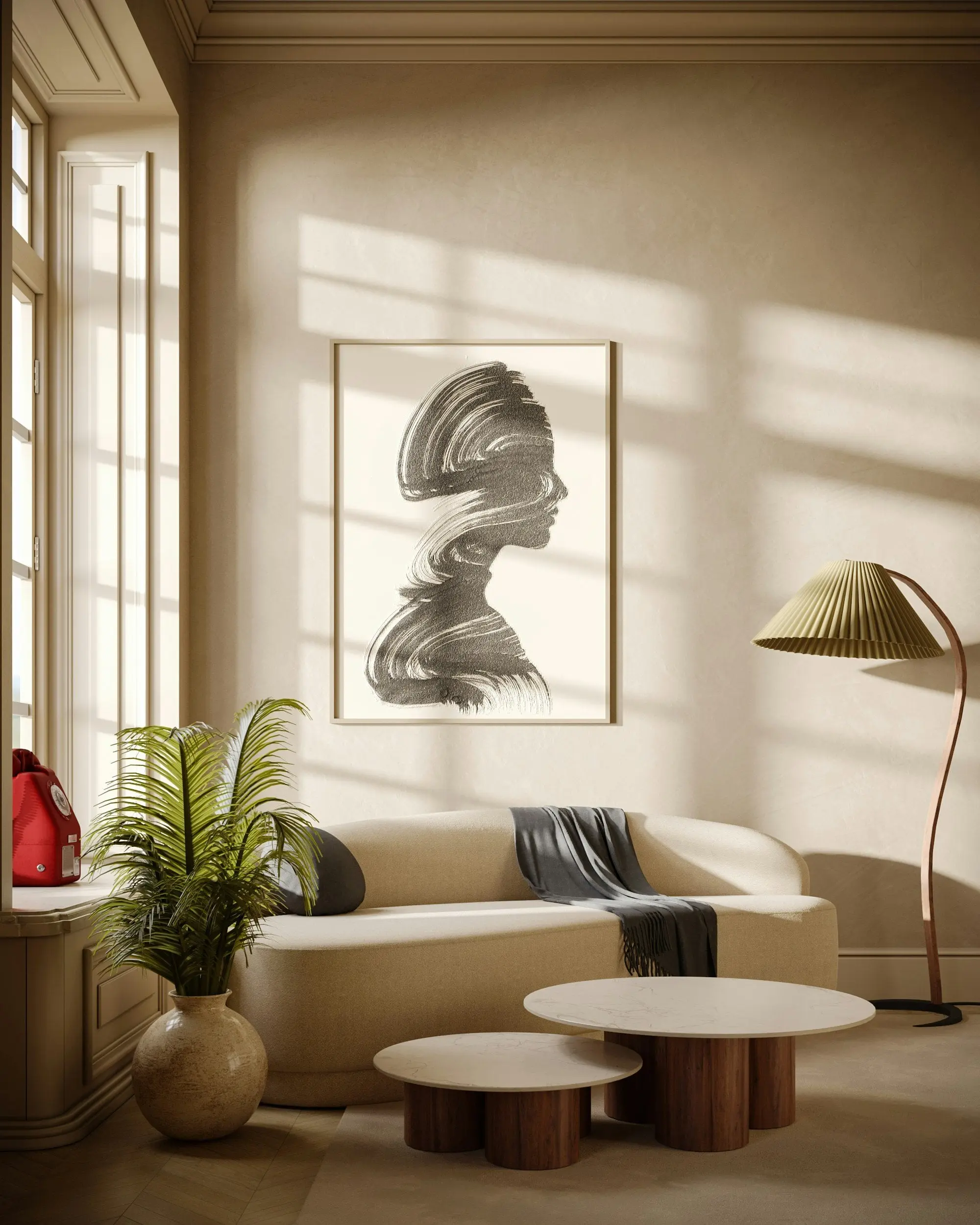 Warm neutral sitting area with curved seating, layered tables, and statement artwork, styled for a sophisticated residential interior.